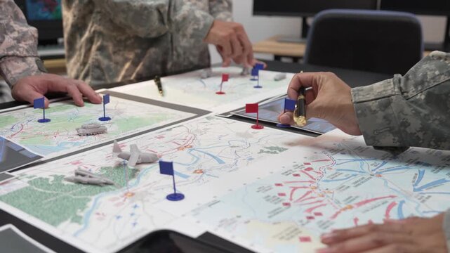 Military Officers Planning Battle Strategy using Tactical Map, Flags and Models on Table
