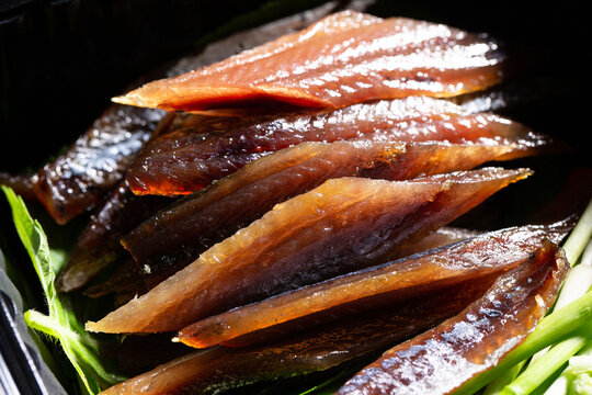 Korean semi-dried Pacific saury known as Gwamegi in black takeout container