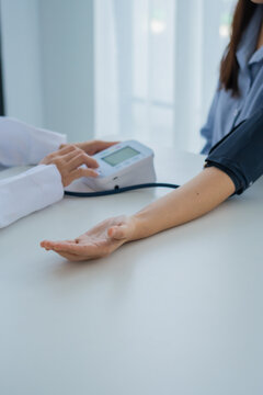 Doctor cheking patient's blood pressure