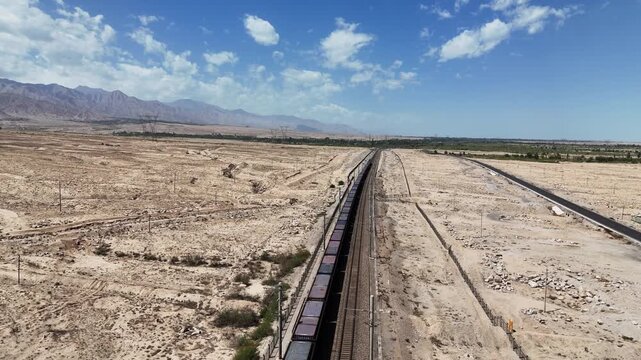 long freight train stretching across the desert landscape