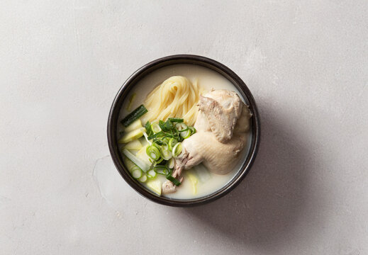 Korean chicken soup with noodles known as Samgyetang in earthenware pot