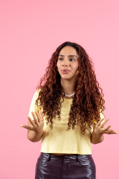 Young woman gesturing expressing confusion or doubt