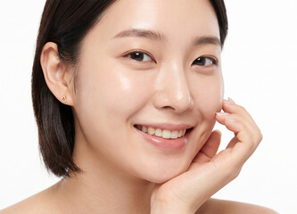 Obraz premium Close up portrait of a cheerful young Asian woman smiling on white background