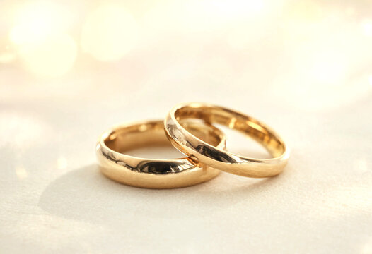 Two Gold Wedding Rings Placed Side by Side on Soft Surface