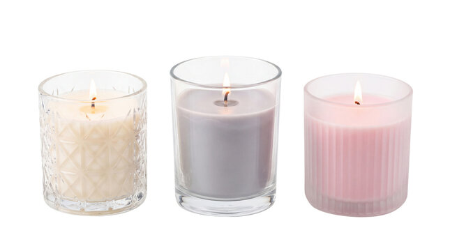 Aromatic scented candles in clear glass jars, burning spa relaxation candles, decorative pastel votive candle set for home wellness