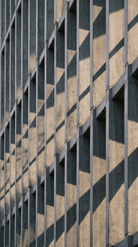 Concrete fins casting diagonal shadows on modern building facade creating abstract geometric with sunlight