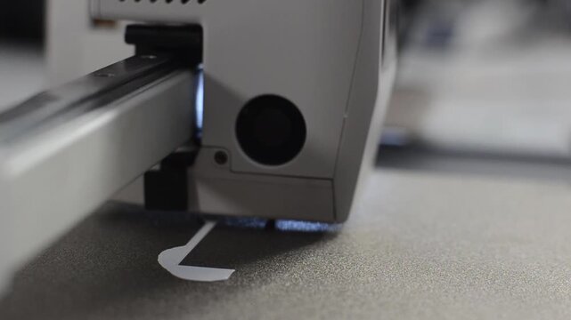 Extreme macro view of a 3D printer nozzle extruding fine plastic layers on print bed