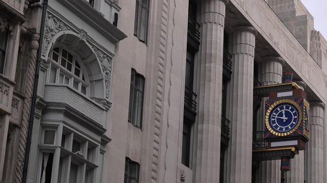Daily Telegraph Building facade with ornate clock and towering columns seen from a low street perspective.
