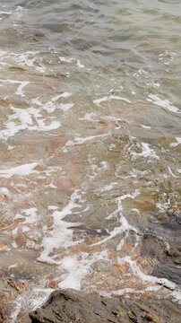 Ocean Waves Gently Washing Over Rocky Shoreline