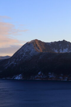 Mount Kamui rising above Lake Mashu at winter dawn in Hokkaido, Japan