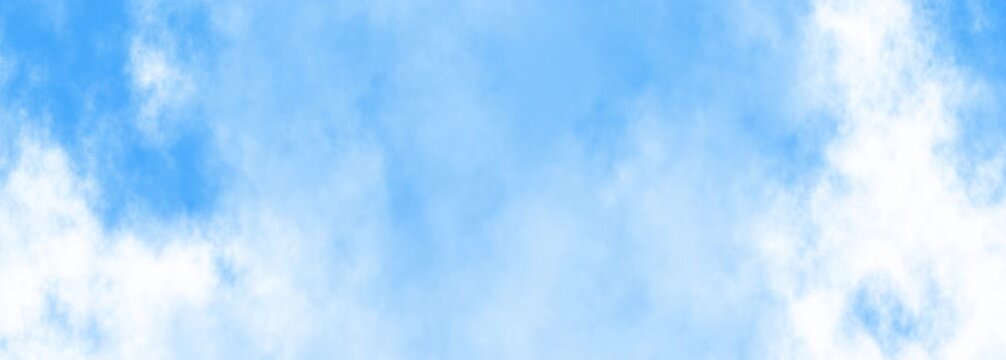Blue sky with fluffy white clouds resembles cotton candy, creating a dreamy celestial atmosphere. Ideal for backgrounds or nature designs.