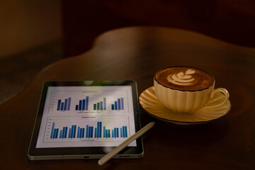 Business Planning with Data Analytics Tablet and Latte Coffee on Wooden Table © nuraporn