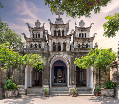 Facade of the historic Nha tho Thanh Giuse Catholic Church in Kien Lao, Nam Dinh, Vietnam, featuring a unique fusion of traditional Vietnamese and European architectural styles