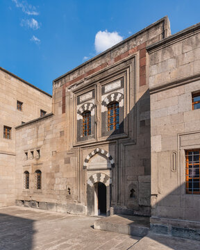 Historic stone facade of the Gupgupoglu Konagi, the Kayseri Ethnography Museum in Kayseri, Turkey, showcasing traditional Seljuk architecture with intricate archway detail under a bright blue sky
