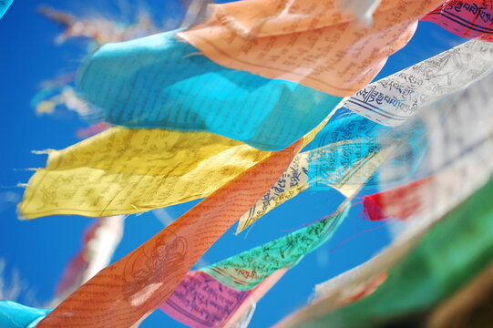 Colorful prayer flags fluttering in the clear blue sky