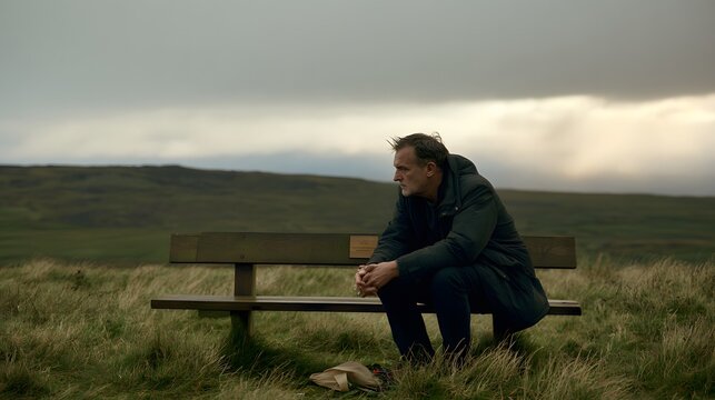 Man Sitting Alone on Memorial Bench Remembering Loved One.