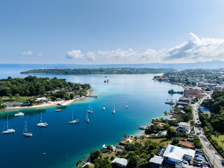 Fototapeta premium Aerial view of Port Vila harbour with sailboats, Iririki Island on the left and Port Vila CBD waterfront in the distance, Vanuatu