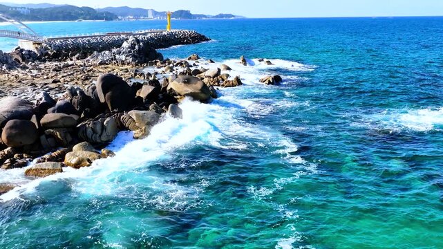 Dynamic fast-speed FPV drone shot flying low over heavy ocean waves in South Korea East Sea.