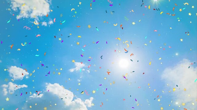 Colorful confetti and gold stars falling against a bright sunny sky with white clouds with video multicolored confetti slowly falling through star shapes slowly through clear blue celebration joy