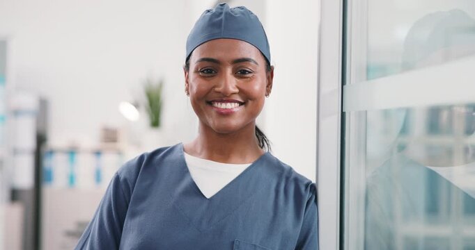 Medical, face and woman in hospital with smile, surgical assistant and pride in patient care. Wellness, portrait or happy nurse with confidence, preoperative specialist or about us in health industry