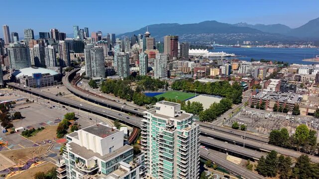 Downtown Vancouver Skyline - BC Place, Rogers Arena, Andy Livingstone Park, Georgia Viaduct, And North Shore Mountains In British Columbia, Canada. - aerial shot