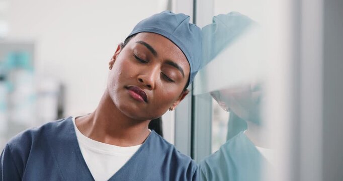 Tired, woman or nurse with stress on glass window for medical failure, mistake or bad procedure. Exhausted, female person or surgeon with reflection or fatigue for surgical crisis or loss in hospital