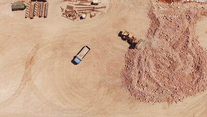 Aerial view of bulldozer moving earth at construction site © Nasos Zovoilis
