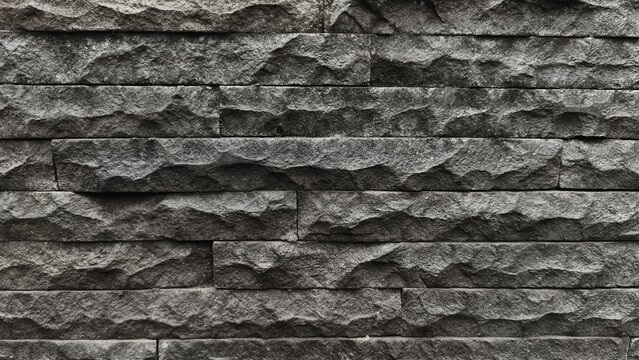 Modern black stone wall texture background, dark slate stone cladding cladding tiles 