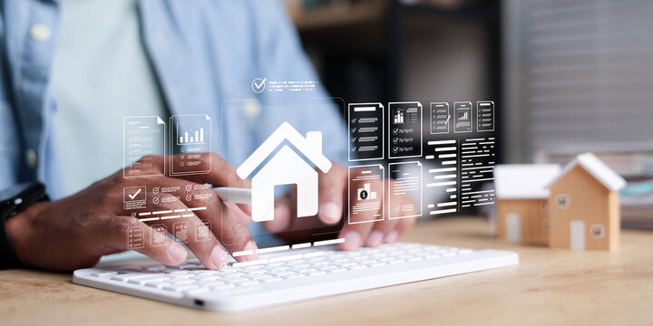 Close up man hands using keyboard with digital real estate, document management system, mortgage loan, property insurance icon HUD on desk.