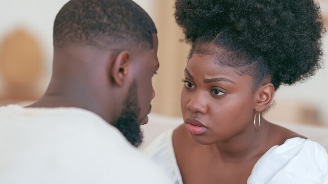 Grumpy Brown woman is having a serious conversation with her man: is she jealous? Envy