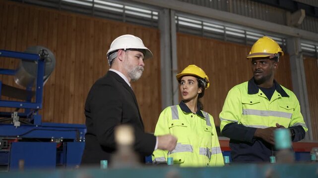 Businessman discusses production plan with engineers