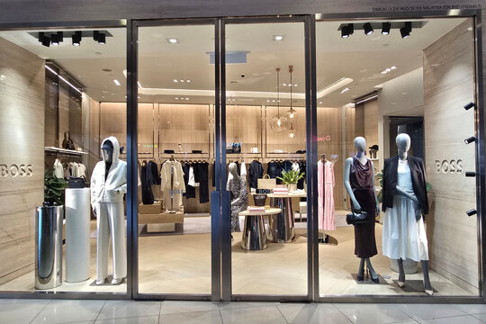 Penang, Malaysia - Sep 06, 2026: Glass entrance and window display of Boss luxury fashion boutique in a shopping mall showcasing modern apparel and dressed mannequins.