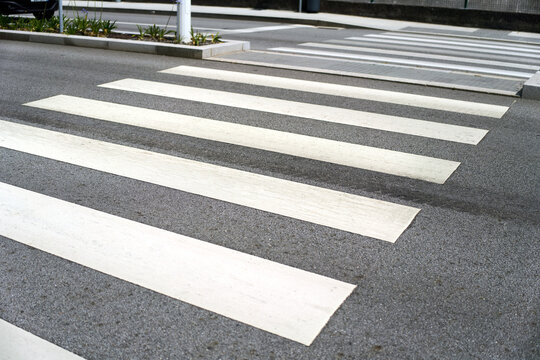Empty walkway lines on asphalt pedestrian crossing
