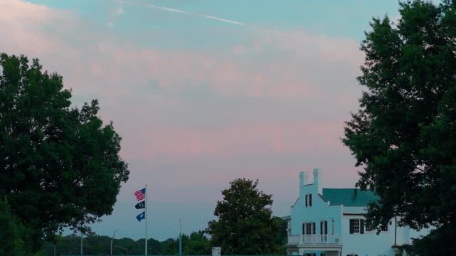 Establishing shot of a beautifully restored 1860s era estate featuring classic Southern architectural elements, a green roof, and pristine landscaping. Paducah, Kentuky, USA