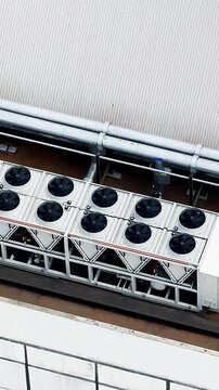 Aerial view of rooftop HVAC units and piping system. 