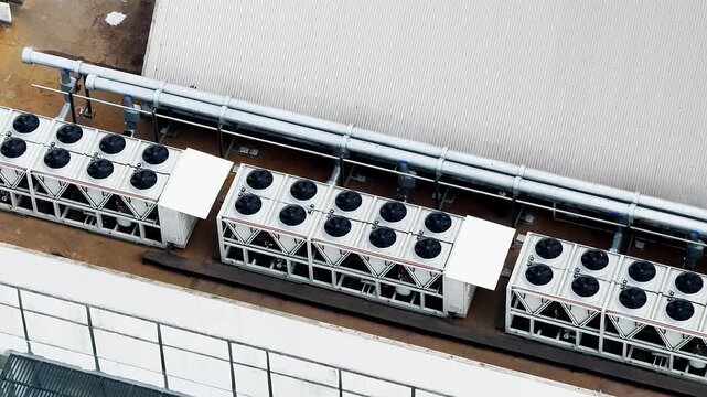 Aerial view of rooftop HVAC units and piping system. 