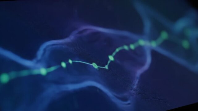 Glowing abstract energy flow with green particles against a dark blue background