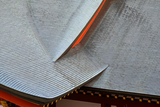 view of intricate traditional Japanese temple roof curves and layered architecture in Hiroshima, Japan