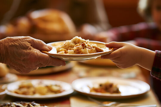 Sharing food during Thanksgiving celebration with family members at the dining table