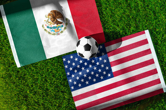 Mexico vs. United States of America football match. National flags on green grass with soccer ball in the middle. Football background for international match.
