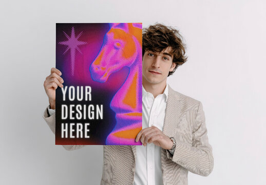 Mockup PSD Of A Man Holding A Poster With Customizable Design Space