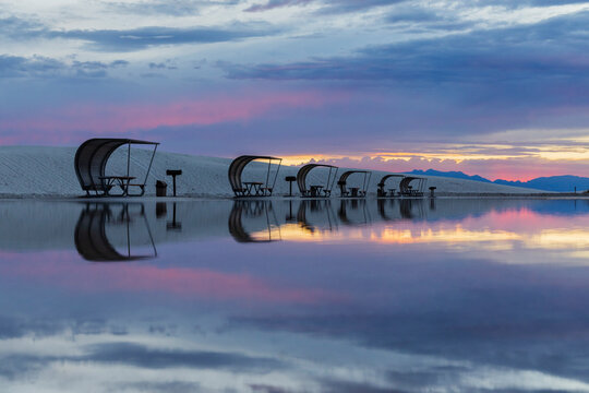 Picnic shelters reflected at sunset