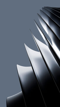 Close-up of shiny metal turbine blades with curved edges