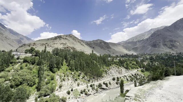 Tari Shing Village spreads among dense trees below barren mountains, Astore, Gilgit-Baltistan, Pakistan