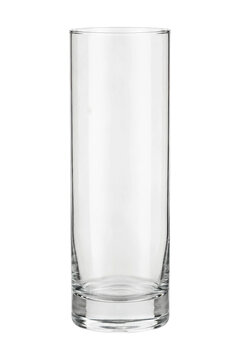 Single empty clear glass tumbler with a thick base stands upright on a clean white background