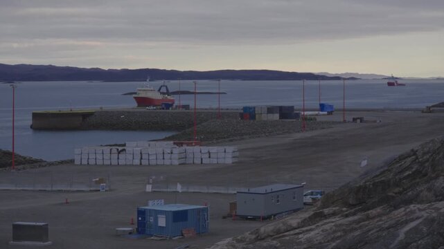 Wide camera timelapse showing port staging ground with Mersey Venture navigating channel and Molly Kool anchored in background