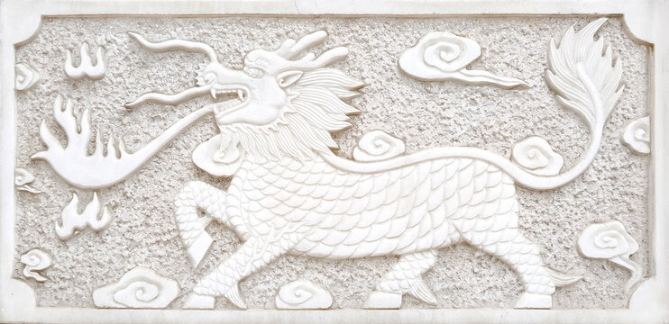 Traditional Chinese Kirin bas-relief sculpture on white stone wall