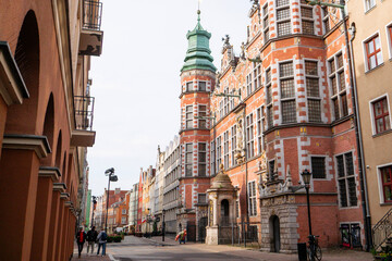 Obraz premium Exterior view of the historic renaissance Great Armoury building facade on a traditional street in Gdansk Old Town Poland, European cultural heritage landmark and urban tourism concept
