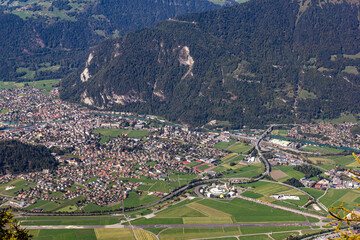 Obraz premium Top view from Schynige Platte over Swiss Alps town Interlaken with the permanently closed amusement Jungfrau Park,
