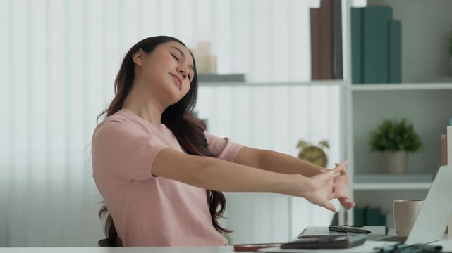 Asian woman takes a break from work. Relax and stretch